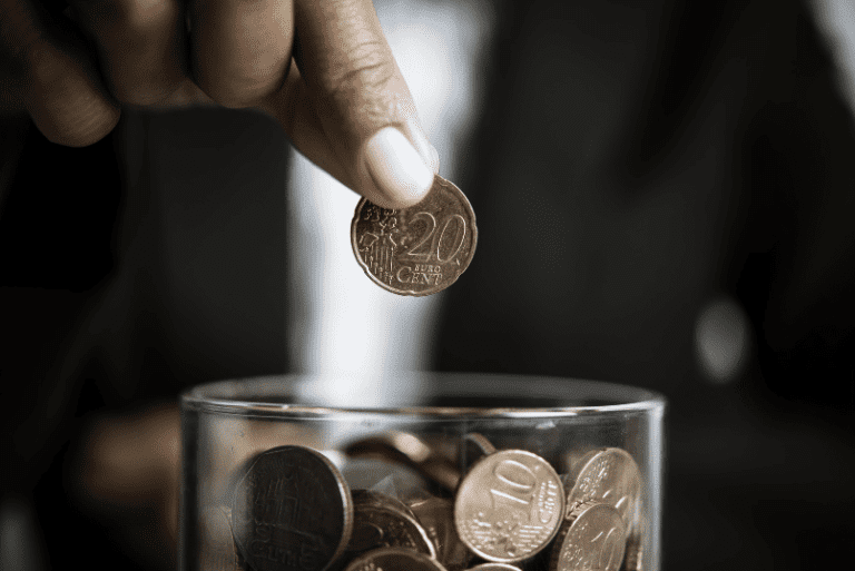 guy putting coins in a jar