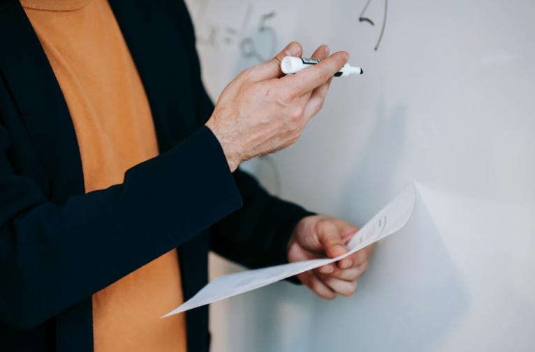teacher writing on whiteboard