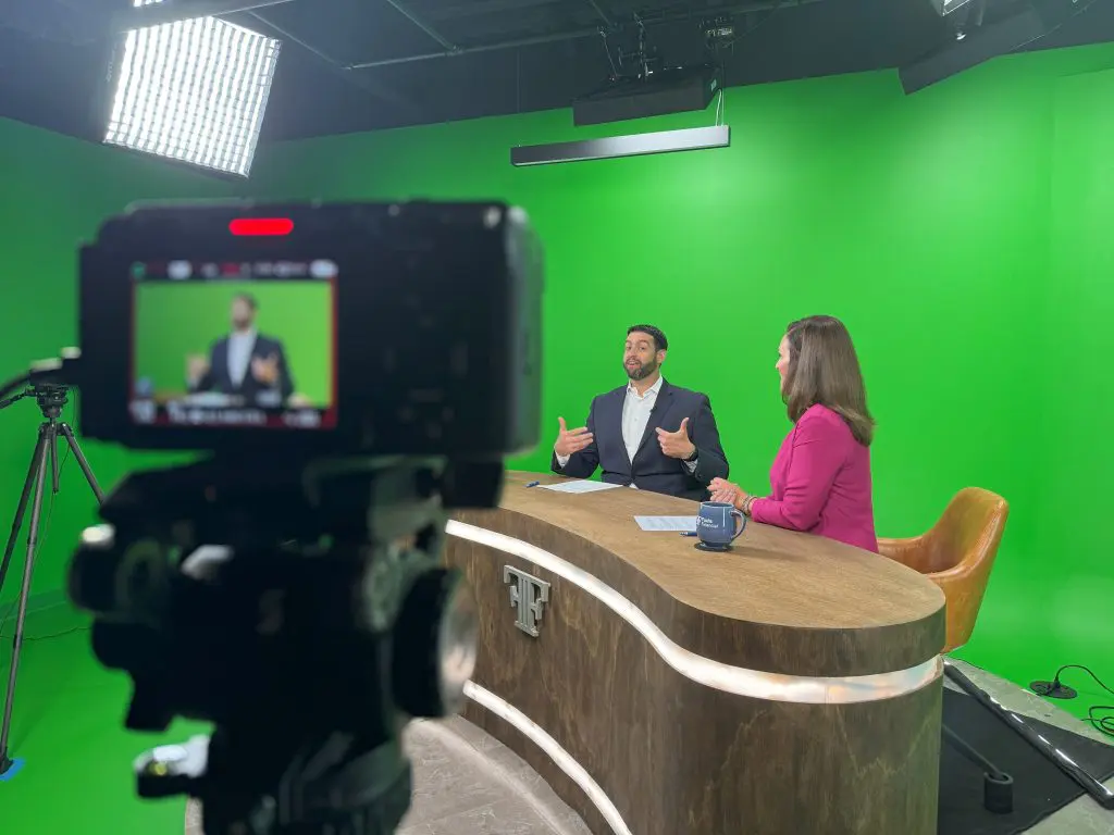 Ben Fuchs and Jackie Brousseau hosting How To Retire with Ben Fuchs with them at a table and the camera on the left