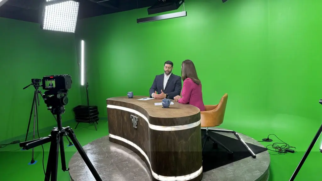 Full picture of the Fuchs Financial studio showcasing the equipment, green screen, cameras, lights, and Ben Fuchs and Jackie Brousseau