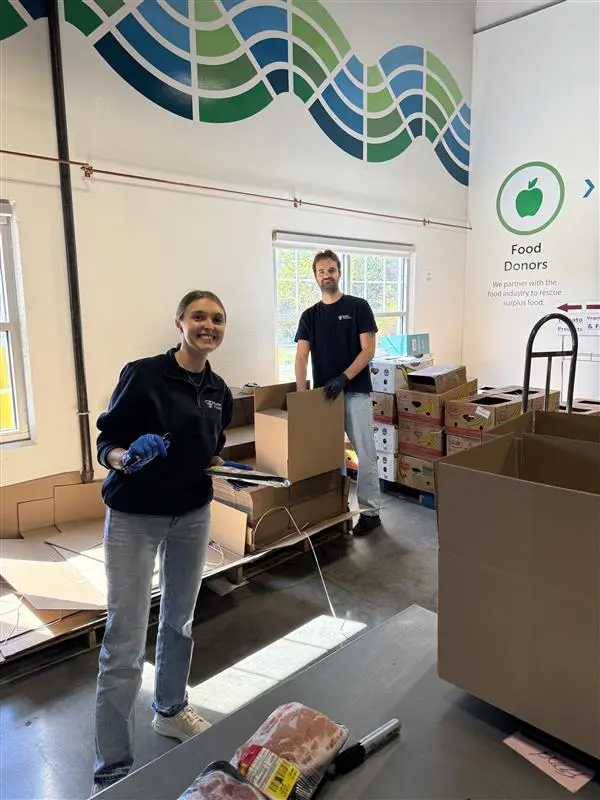 Director of Marketing, Kate Smith, and Retirement Healthcare Benefits Analyst, Josh Kerchis, of Fuchs Financial at the Connecticut Foodshare Food Bank.