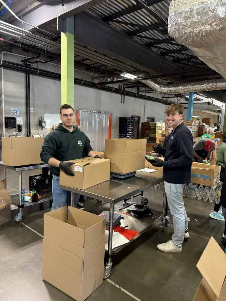 Financial Advisor, Alex Cal, and Digital Marketing Specialist, Brandon Holland, at the CT foodshare food bank in Wallingford Connecticut