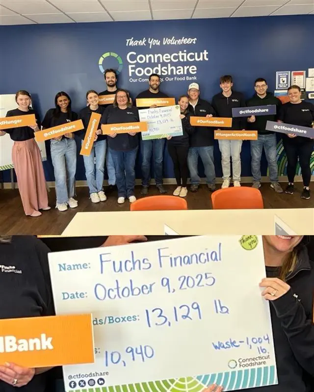 The Fuchs Financial Team with their scorecard of how many meals they voluntarily supplied
