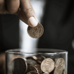 guy putting coins in a jar